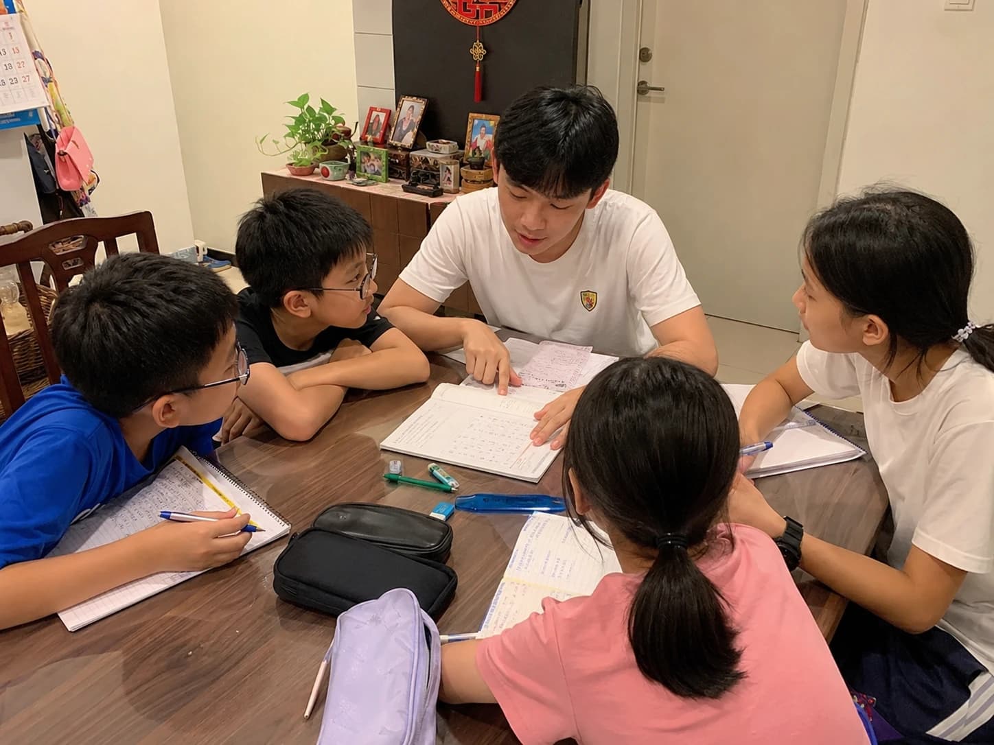 A tutor leading a small group tuition session