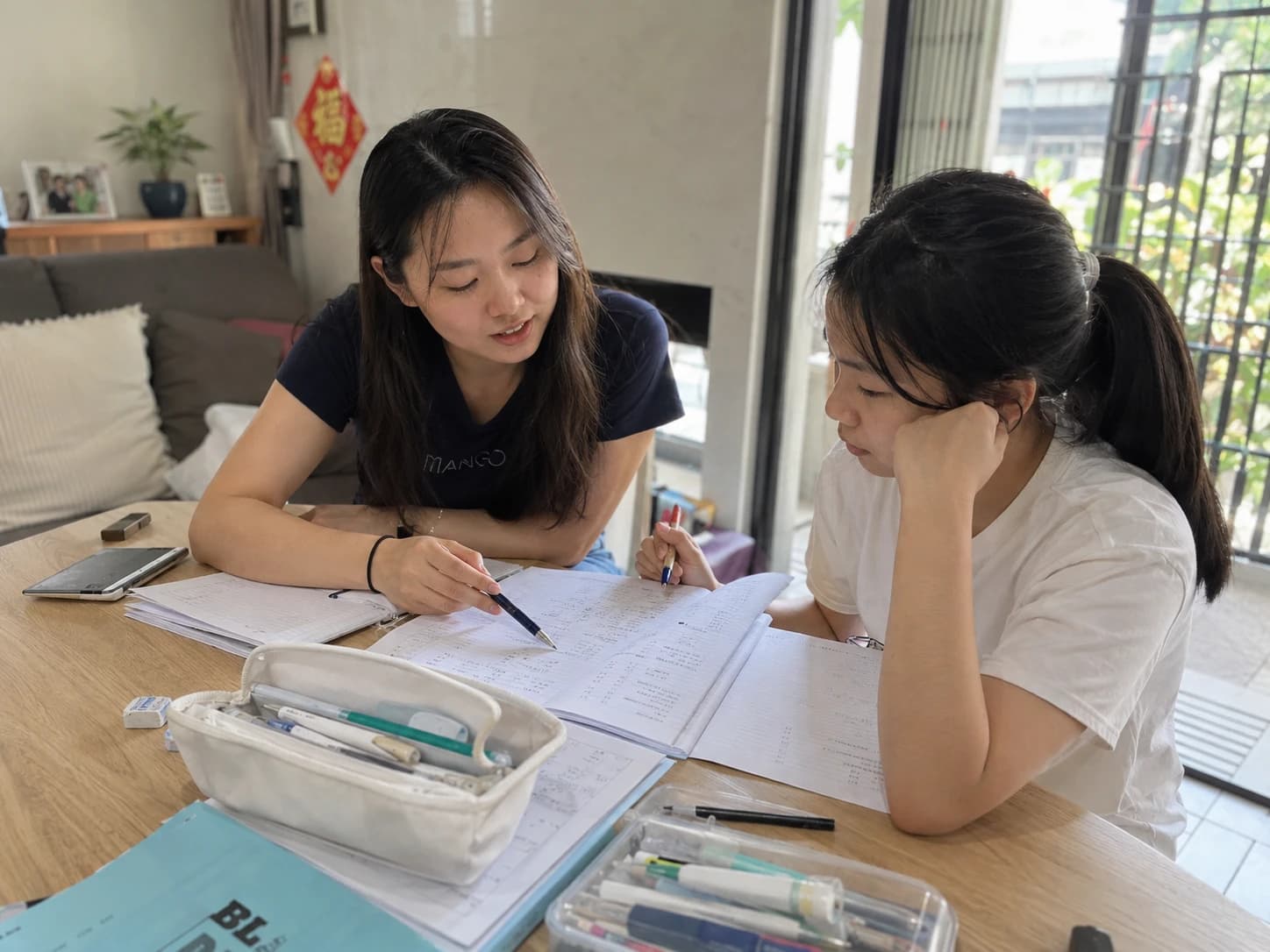 A tutor guiding a student through her schoolwork