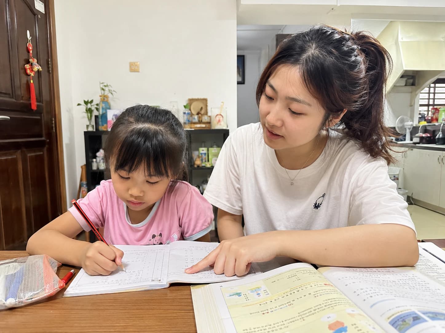 A tutor helping a young student complete an exercise