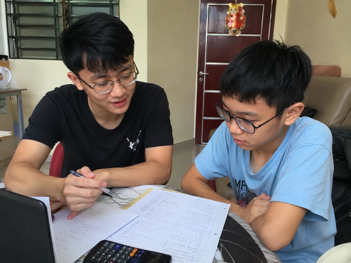 A tutor explaining schoolwork to a student