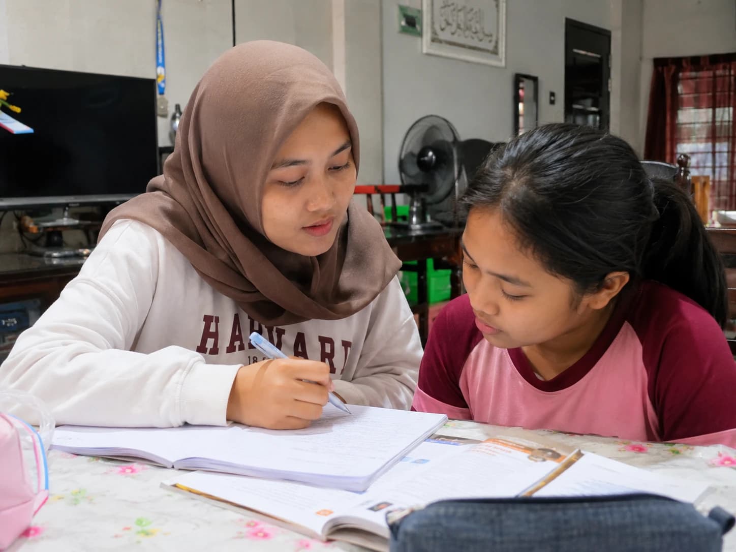 A tutor reviewing written work with a student