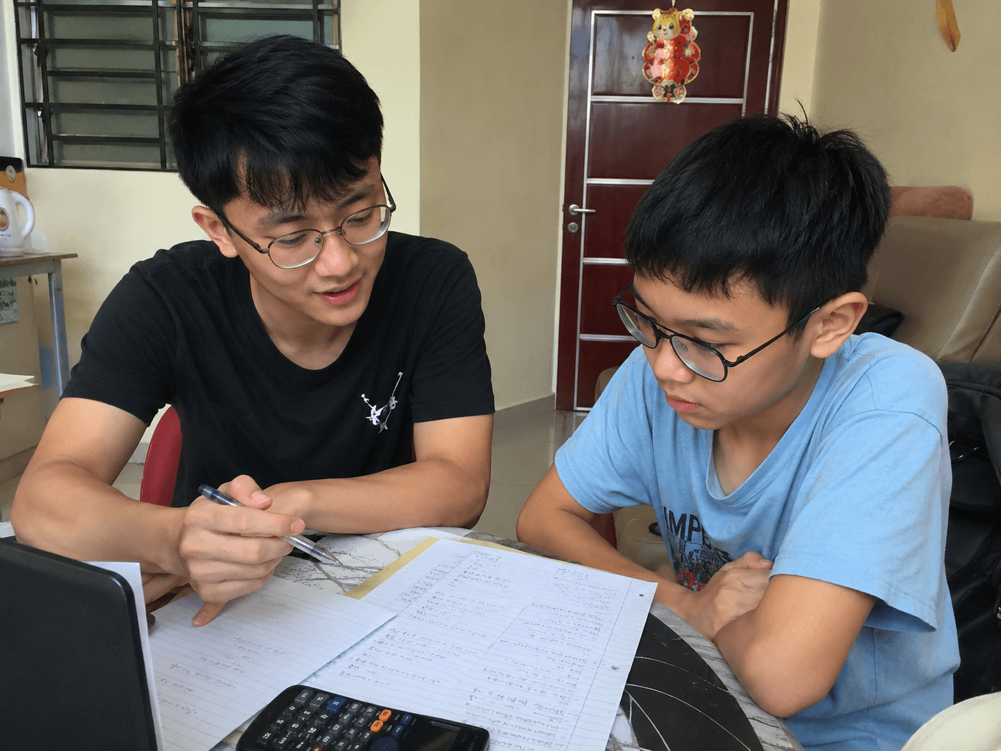 A tutor explaining schoolwork to a student
